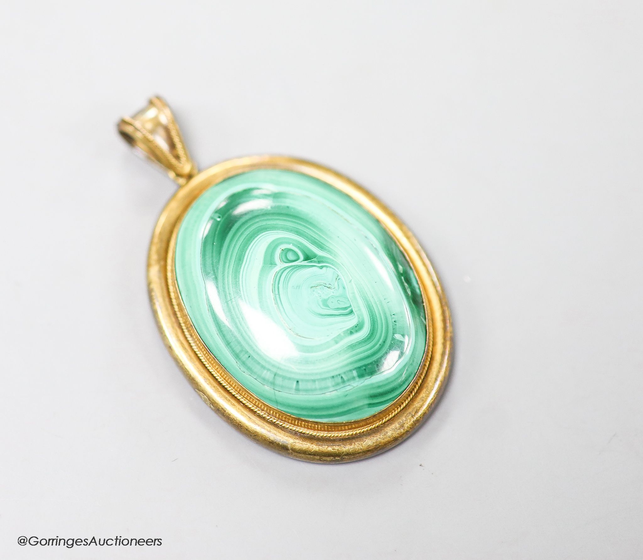 A Victorian yellow metal and malachite set oval pendant, with glazed back, overall 56mm